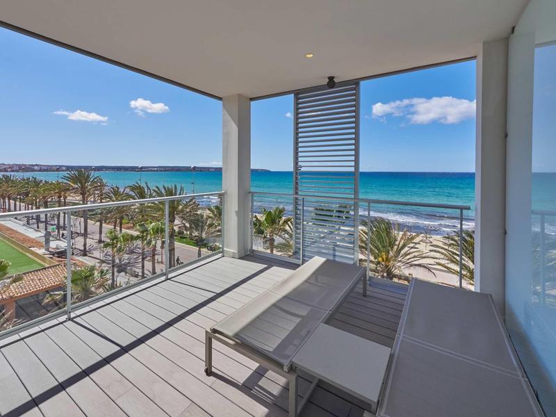 Balkon z leżakami i widokiem na morze w słoneczny dzień