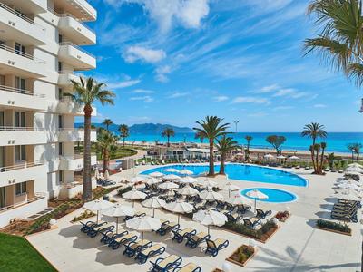 Hotel met zwembad en uitzicht op zee, ligstoelen en parasols op het terras