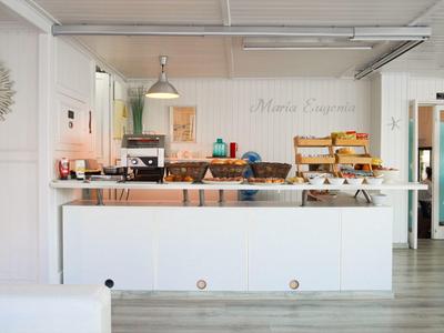 Brightly decorated breakfast area with bread selection and coffee machine in a hotel