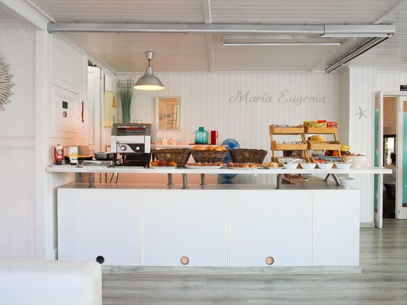 Brightly decorated breakfast area with bread selection and coffee machine in a hotel
