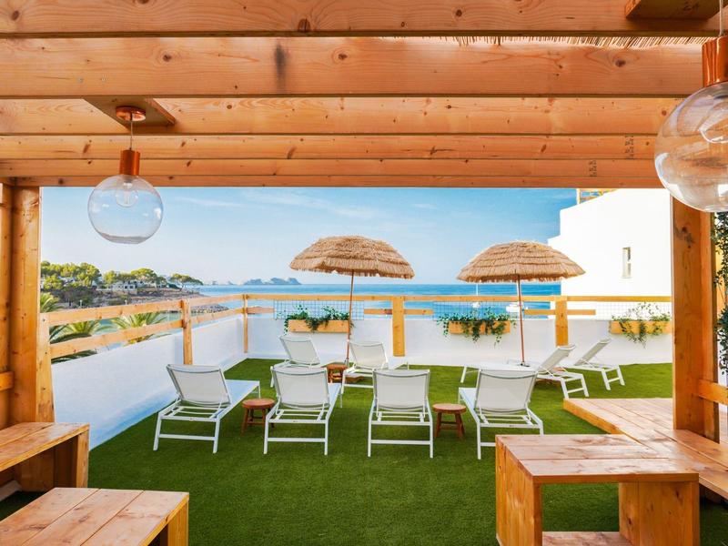 Rooftop terrace with sun loungers and a clear view of the sea