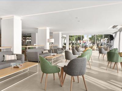 Modernes Hotelrestaurant mit gemütlichen Sesseln und Tischen, viel Tageslicht und hellem Interieur.