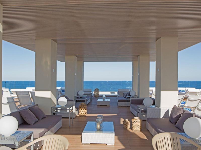 Open modern lounge area with seating and ocean view.