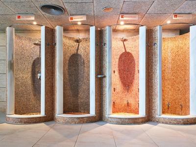 Four different colored steam showers in a modern spa facility.
