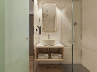 Piccolo bagno moderno con lavandino, specchio e doccia in vetro in tonalità neutre.