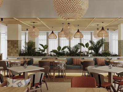 Modern restaurant with wooden tables, chairs, and large plants for decoration.