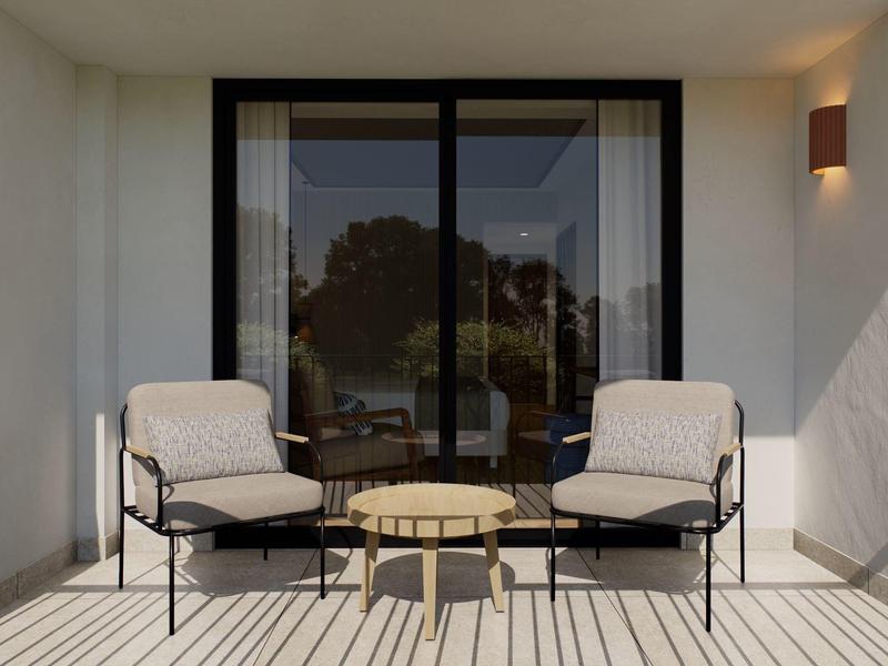 Two cushioned chairs and a small round table on a patio with sliding glass door