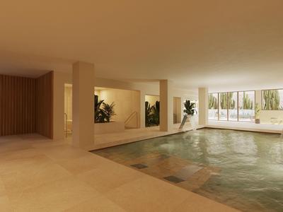 Moderner Innenpool mit großen Fenstern, beige Fliesen und Pflanzen im eleganten, offenen Raum.