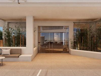 Área moderna de salón abierto en hotel con asientos y paredes de vidrio.