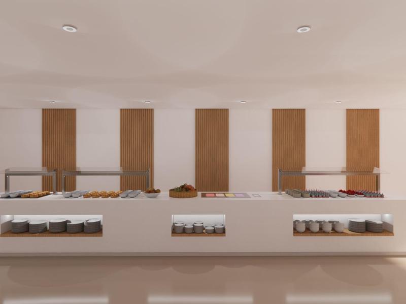 Nowoczesna stacja bufetowa z białym blatem i drewnianymi akcentami w jasnym pomieszczeniu.