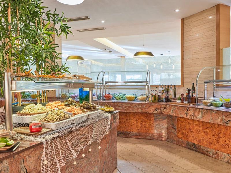Buffet area with various fresh dishes and modern wooden decor in a restaurant.