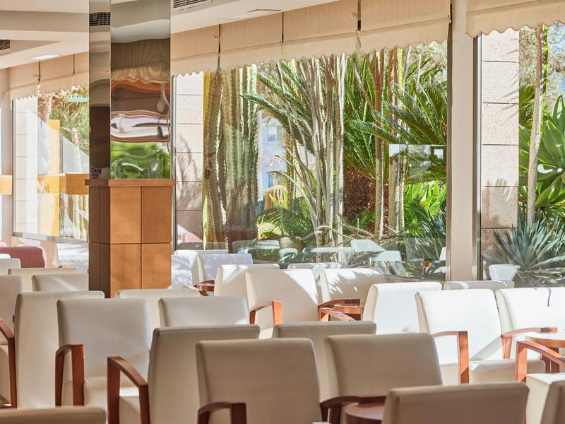 Bright, modern restaurant with large windows and cozy seating areas.