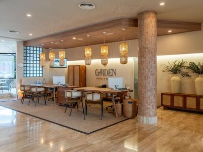 Modern hotel lounge area with tables, chairs, and decorative elements.