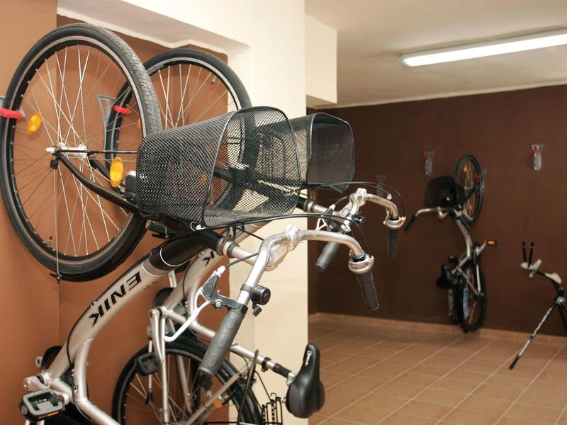 Des vélos sont accrochés aux supports muraux dans un couloir.