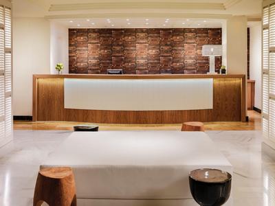 Modern hotel reception with wooden accents and a minimalistic design.