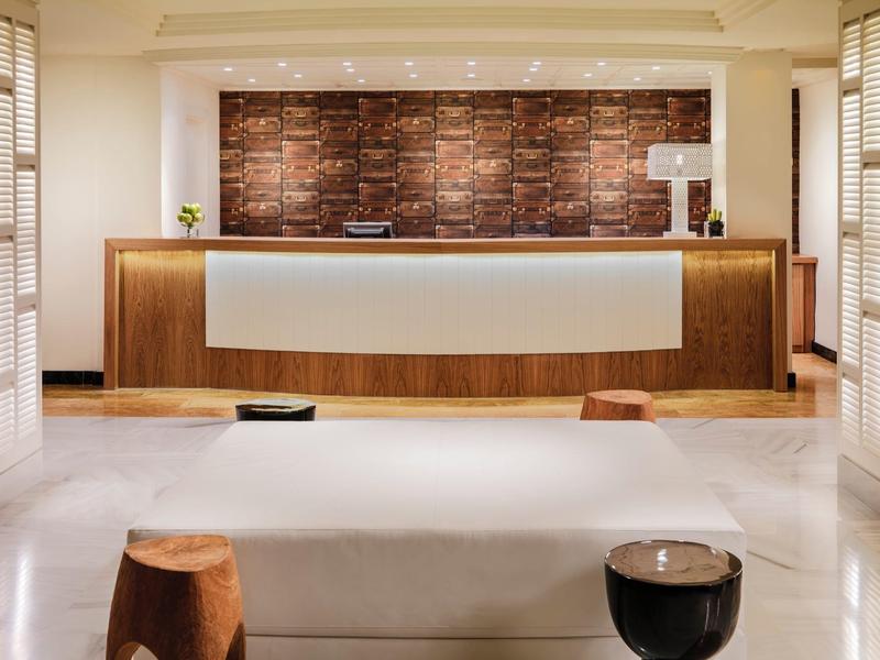 Modern hotel reception with wooden accents and a minimalistic design.