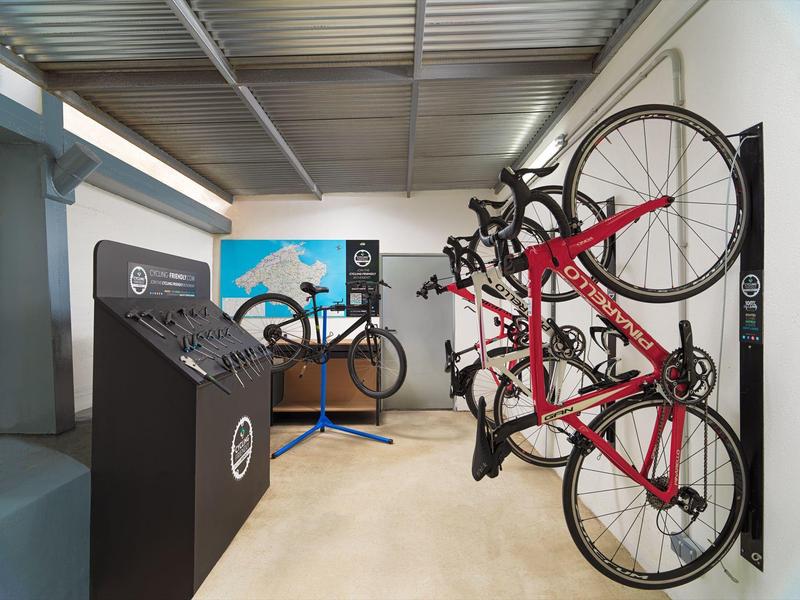 Modern bike storage with several bicycles secured on a rack in a clean indoor area.