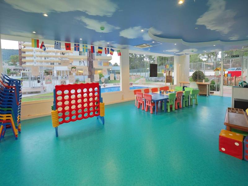 Bright children's play area with colorful furniture and toys in a hotel.