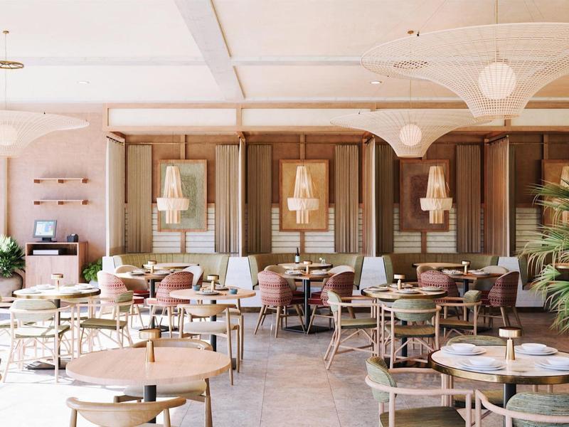 Jasna, przyjazna restauracja z okrągłymi stołami i drewnianymi meblami, idealna dla gości.