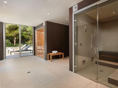 Modern spa with sauna and steam room, bright and minimalist design.