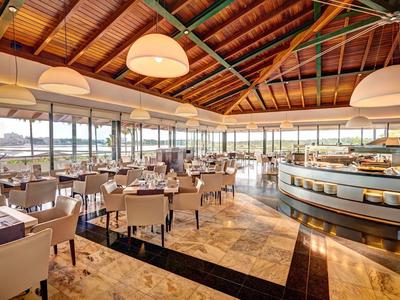 Bright, spacious restaurant with sea views and modern seating arrangements.