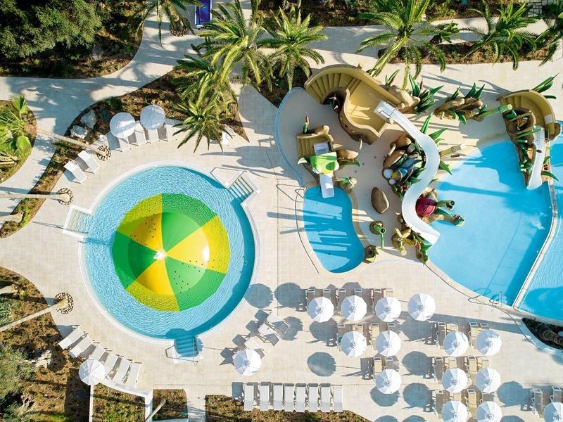 Zdjęcie z lotu ptaka hotelu z basenami, parasolami i roślinami tropikalnymi