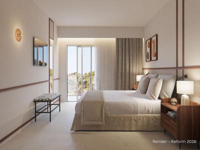 Habitación de hotel moderna con cama doble, mesitas de noche, lámpara y balcón con luz natural.