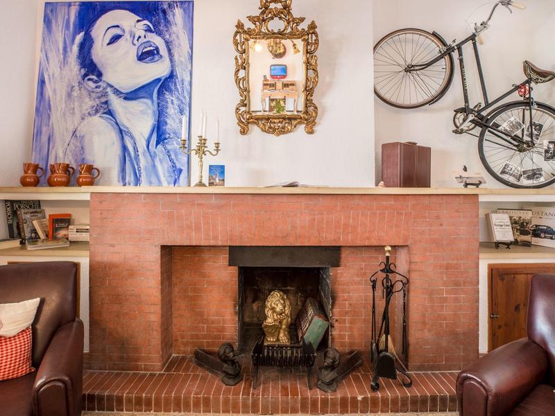 Cozy living room with fireplace, bicycles on the wall, and modern artwork.