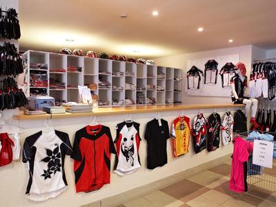 Półki i ściana z różnymi kolorowymi koszulkami w sklepie.