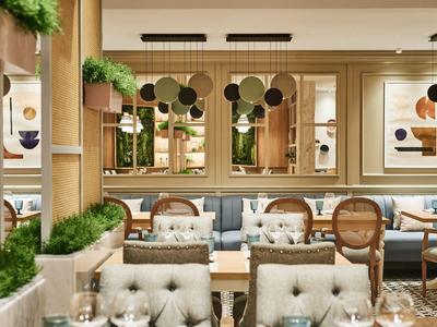 Helles Restaurantinterieur mit hölzernen Möbeln, grünen Pflanzen und abstrakter Kunst an den Wänden