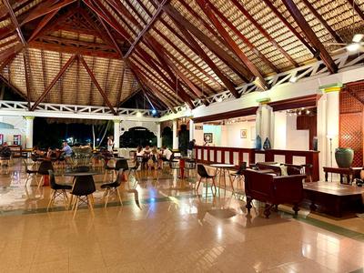 Large open dining area with wooden ceiling and numerous tables and chairs.