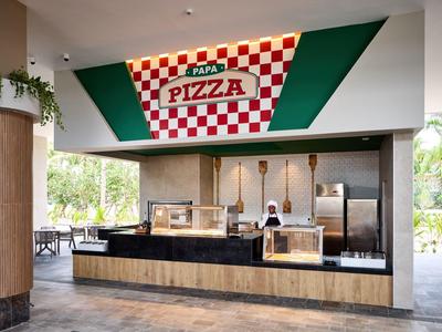 Modern pizza stand with red and white checkered pattern and green background.