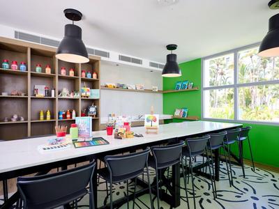 Modern meeting room with long table, black chairs, and large windows.