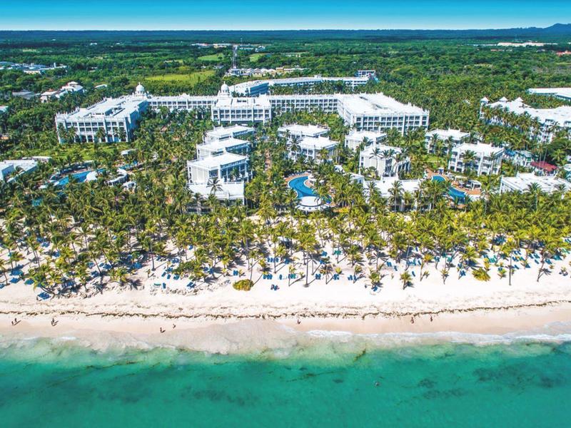 Aerial view of a large resort with sandy beach and turquoise sea.