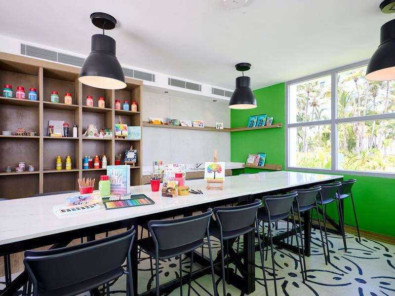 Modern meeting room with long table, black chairs, and large windows.