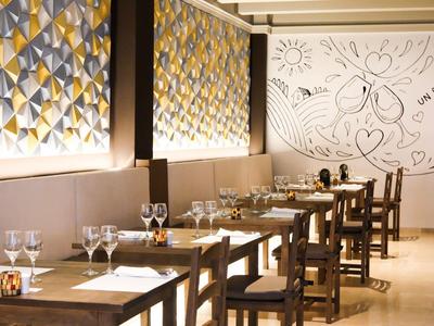 Elegant restaurant with wooden furniture and decorative wall murals.