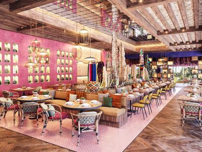 Ampia zona lounge dell'hotel con pareti colorate, posti a sedere confortevoli e illuminazione elegante.