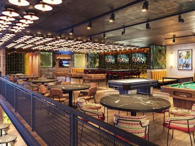 Moderní bar a relaxační prostor s kulečníkovým stolem a pohodlným sezením.