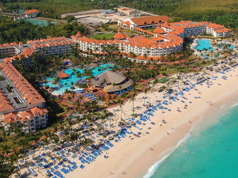 Large beach resort with multiple pools and white sandy beaches by turquoise sea.