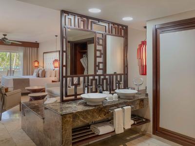 Salle de bain d'hôtel moderne avec doubles vasques et grand miroir.