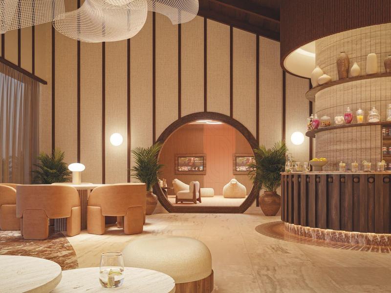 Moderní světlý hotelový salonek s kulatým sezením a příjemným kruhovým průchodem.