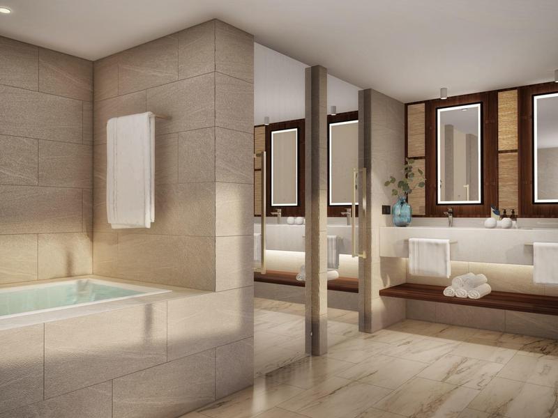 Moderní koupelna s vanou, dvojitými umyvadly a velkými světlými zrcadly.