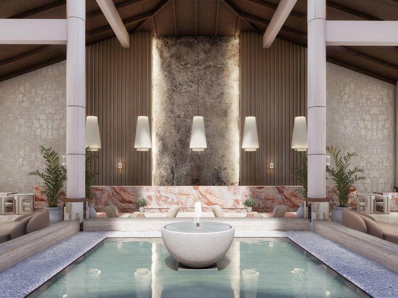 Moderní luxusní hotelová lobby se středovým vodním prvkem a útulnými posezeními.