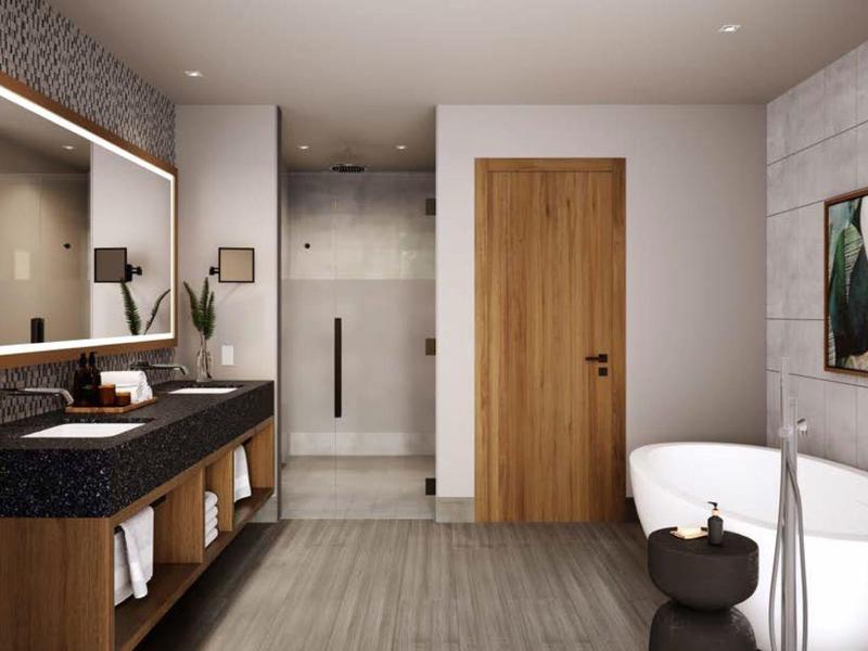 Moderne badkamer met vrijstaand bad, grote spiegel en houten kast.