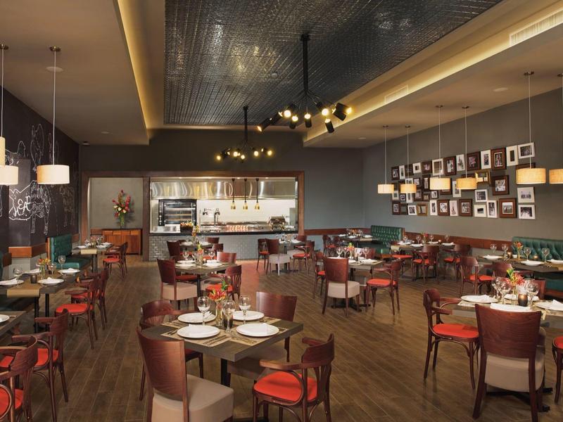 Modern restaurant with elegantly set tables and stylish decor.