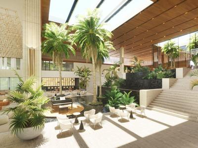 Heller Hotel-Lobbybereich mit großen Pflanzen, Sitzbereichen und natürlichem Licht.