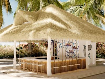 Open paviljoen met rieten dak en zitplaatsen in een tropische hoteltuin.