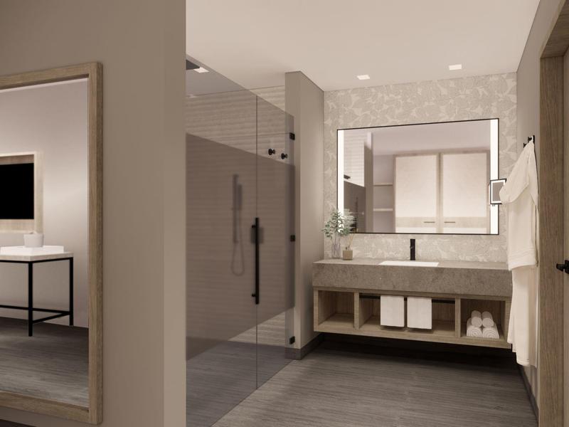 Nowoczesna łazienka z dużym lustrem, prysznicem, umywalką i ręcznikami.