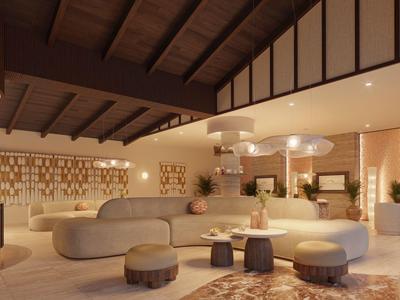 Hall d'hôtel moderne avec canapés confortables et éclairage décoratif.