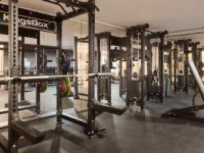 Modern gym with weight training equipment in a hotel.